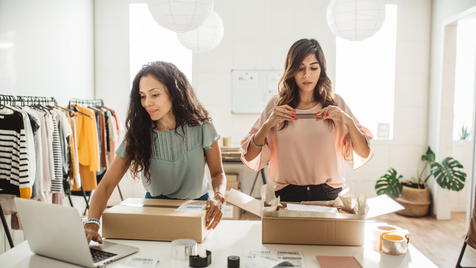 Two women creating packages for their small business